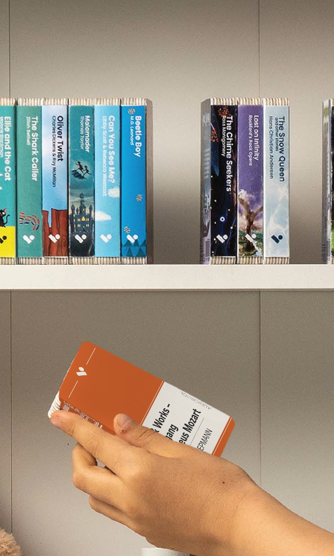 A hand taking the Life & Works – Wolfgang Amadeus Mozart audiobook from a shelf of Voxblock audiobooks