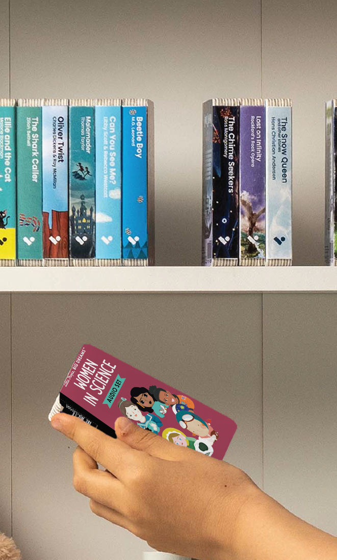 A hand taking the Little People Big Dreams: Women in Science audiobook from a shelf of Voxblock audiobooks