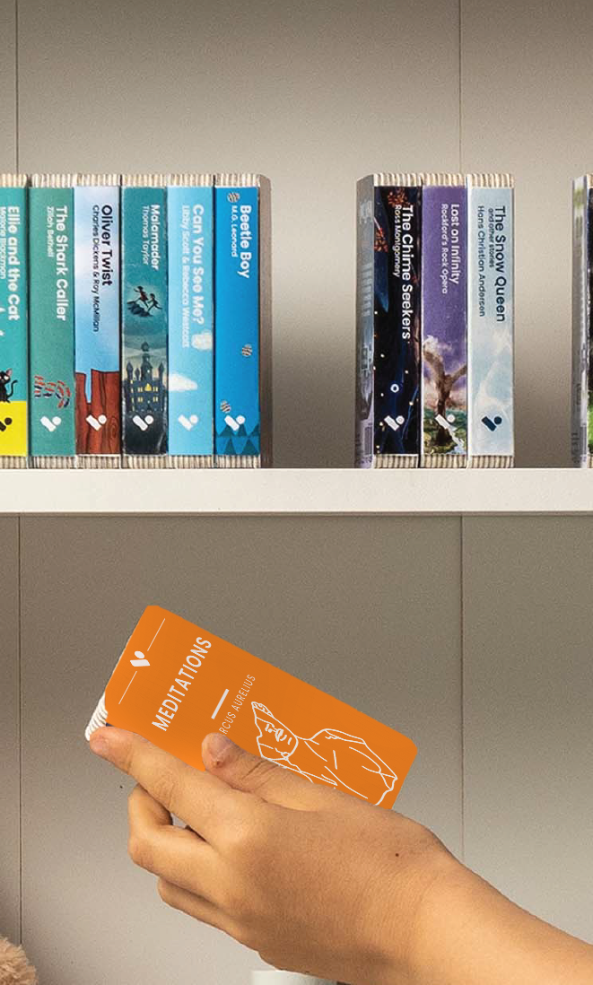 A hand taking the Meditations of Marcus Aurelius audiobook from a shelf of Voxblock audiobooks