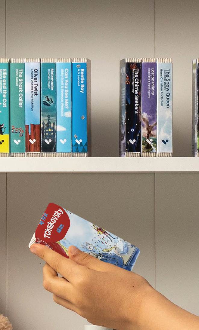 A hand taking the My First Tchaikovsky Album audiobook from a shelf of Voxblock audiobooks