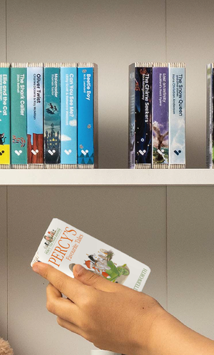 A hand taking the Percy’s Favourite Tales audiobook from a shelf of Voxblock audiobooks