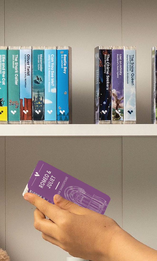 A hand taking the Romeo and Juliet audiobook from a shelf of Voxblock audiobooks