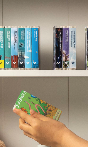 A hand taking the Superworm audiobook from a shelf of Voxblock audiobooks