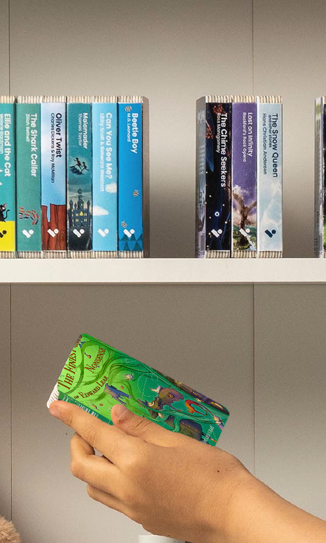 A hand taking The Finest Nonsense of Edward Lear (selections) audiobook from a shelf of Voxblock audiobooks