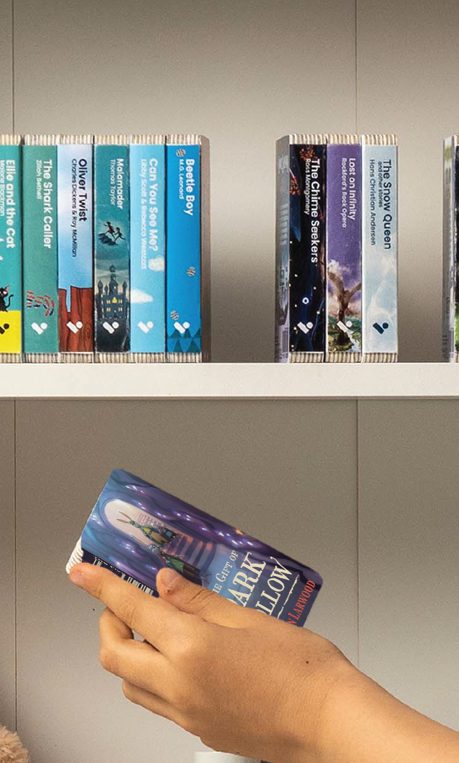 A hand taking The Five Realms: The Gift of Dark Hollow audiobook from a shelf of Voxblock audiobooks
