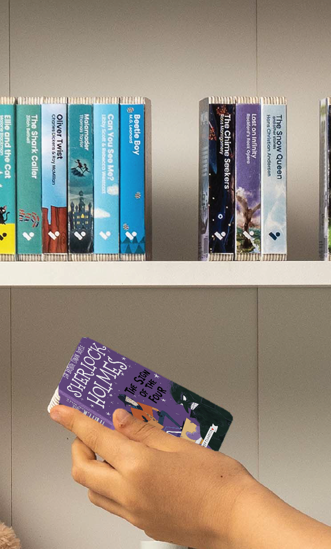 A hand taking The Sign of the Four audiobook from a shelf of Voxblock audiobooks