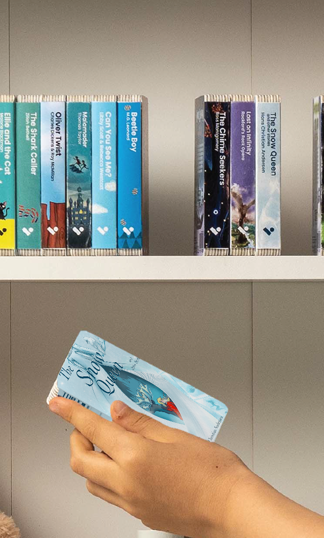 A hand taking The Snow Queen and Other Stories audiobook from a shelf of Voxblock audiobooks