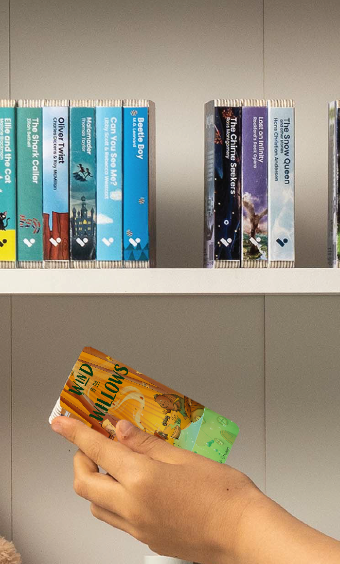 A hand taking The Wind in the Willows audiobook from a shelf of Voxblock audiobooks