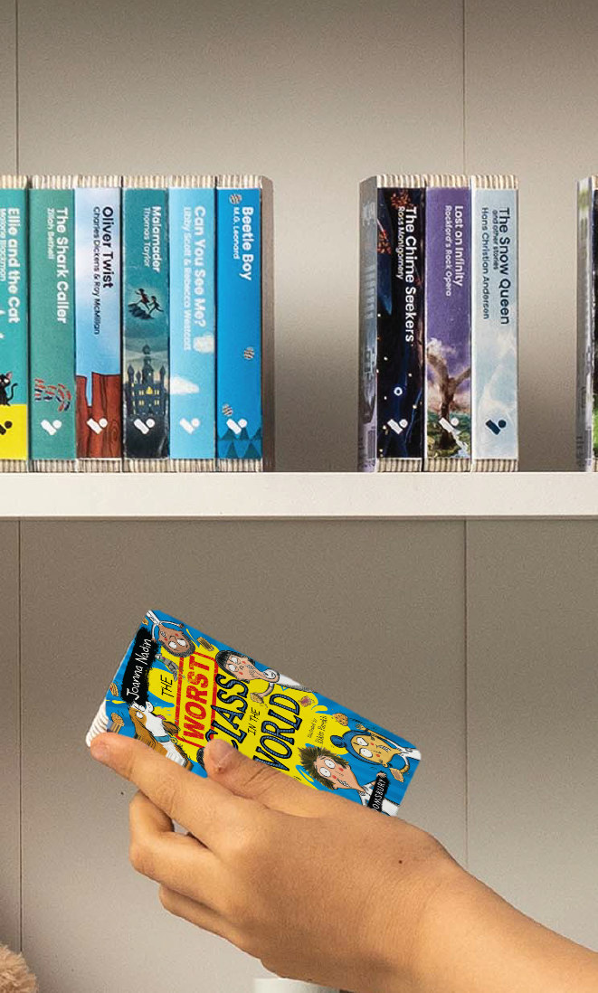 A hand taking The Worst Class in the World audiobook from a shelf of Voxblock audiobooks