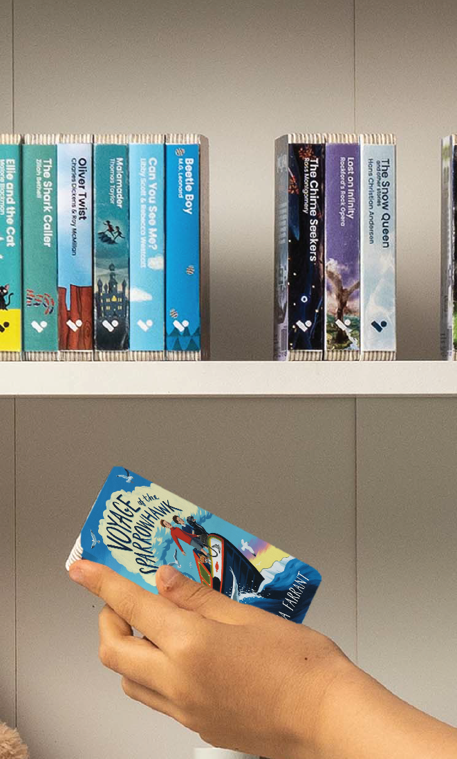 A hand taking the Voyage of the Sparrowhawk audiobook from a shelf of Voxblock audiobooks