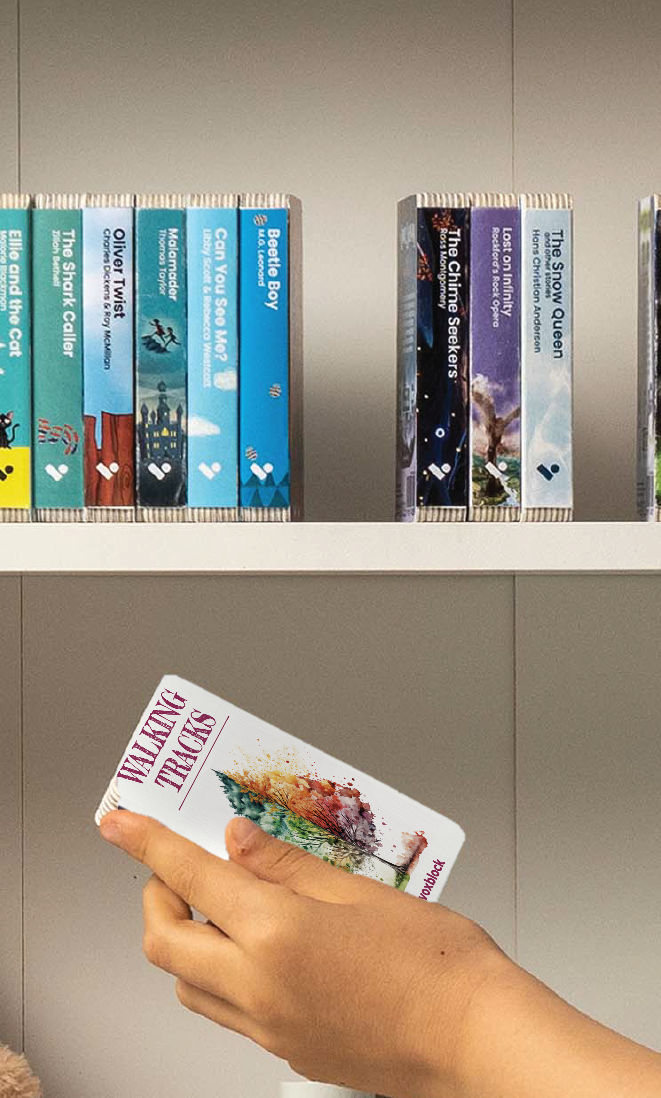 A hand taking the Walking Tracks audiobook from a shelf of Voxblock audiobooks
