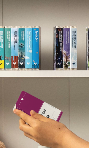 A hand taking the War and Peace audiobook from a shelf of Voxblock audiobooks