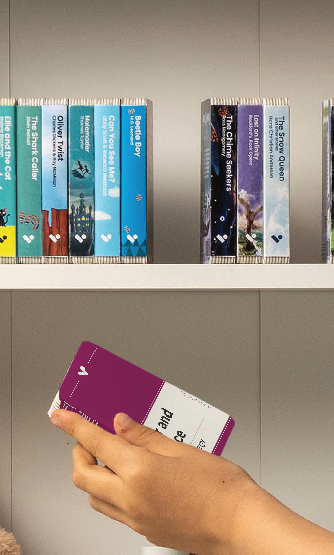 A hand taking the War and Peace audiobook from a shelf of Voxblock audiobooks