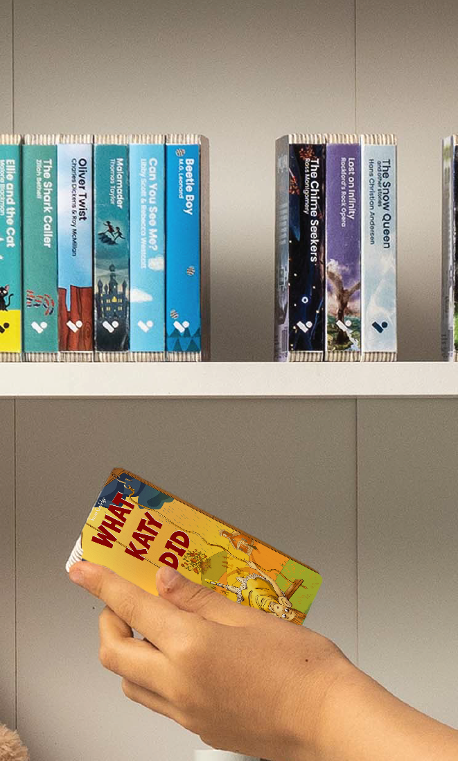 A hand taking the What Katy Did audiobook from a shelf of Voxblock audiobooks